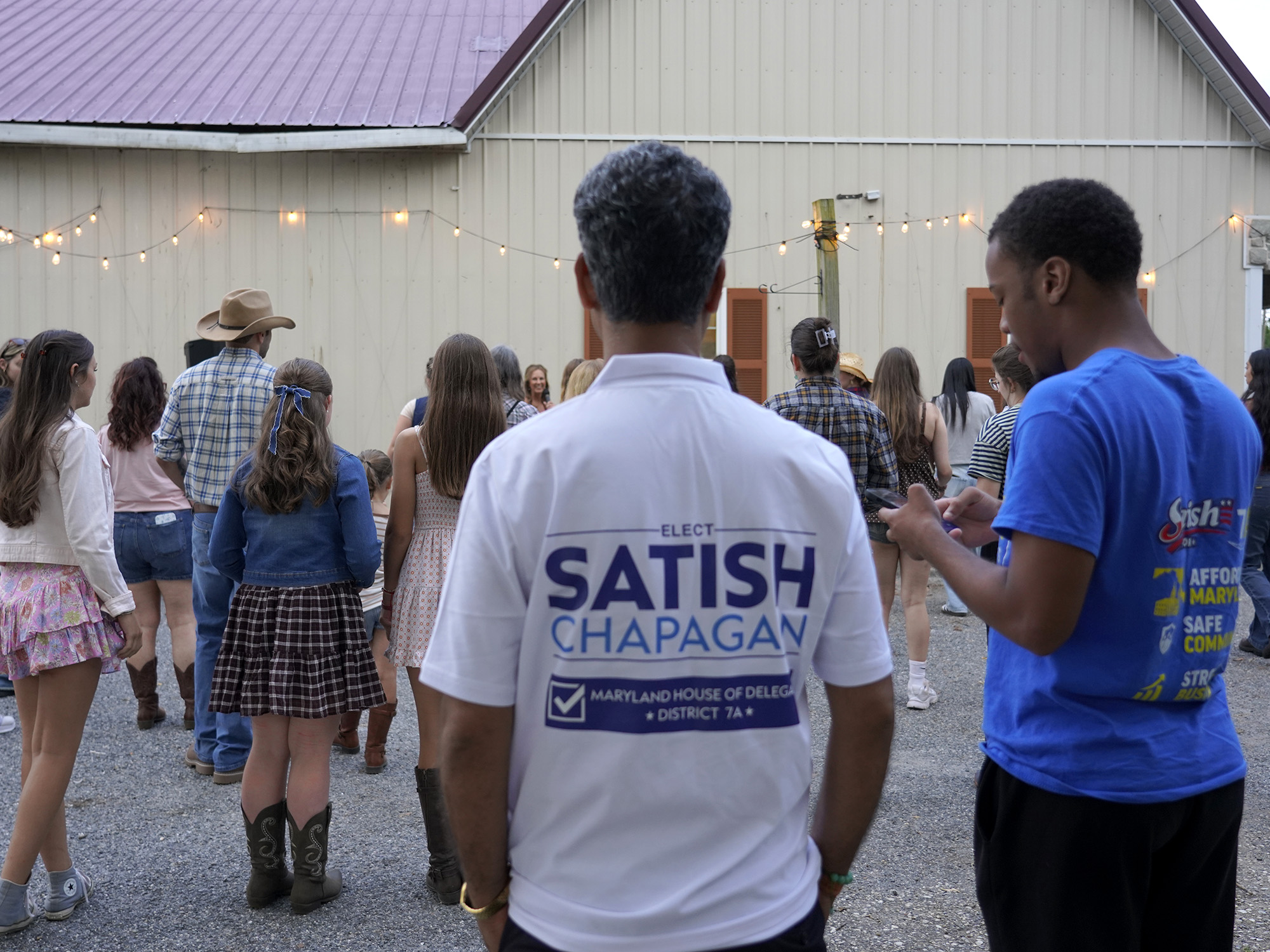 Satish Chapagain in a campaign shirt at a community barn gathering in District 7A
