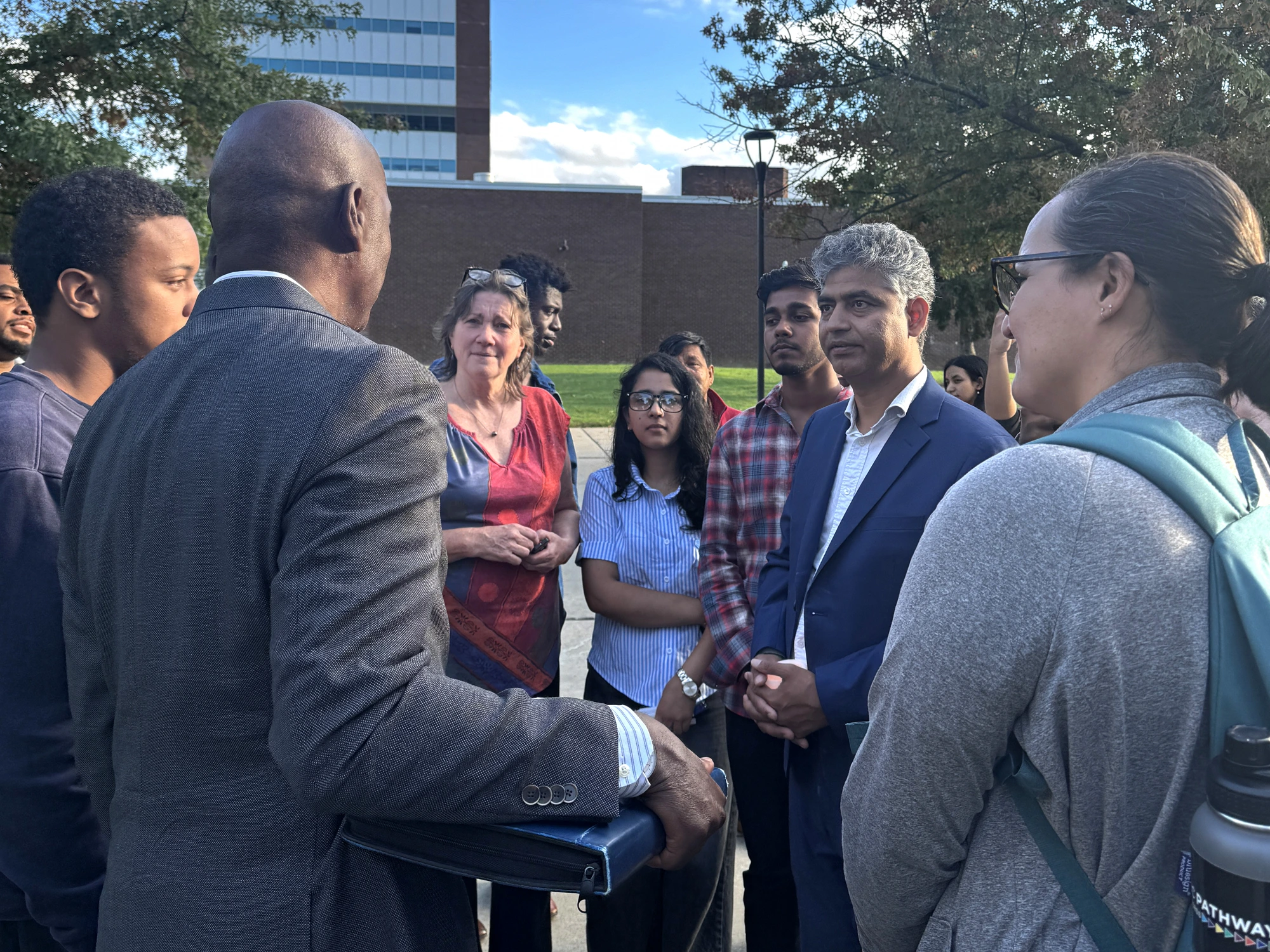 Satish Chapagain talking with students and residents on a college campus